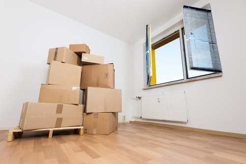 Trained movers carrying furniture safely with PPE and equipment