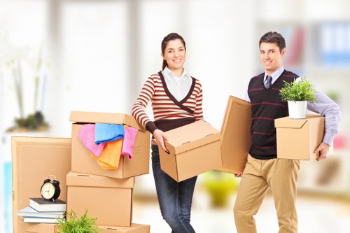 Movers handling desks and equipment during a commercial relocation